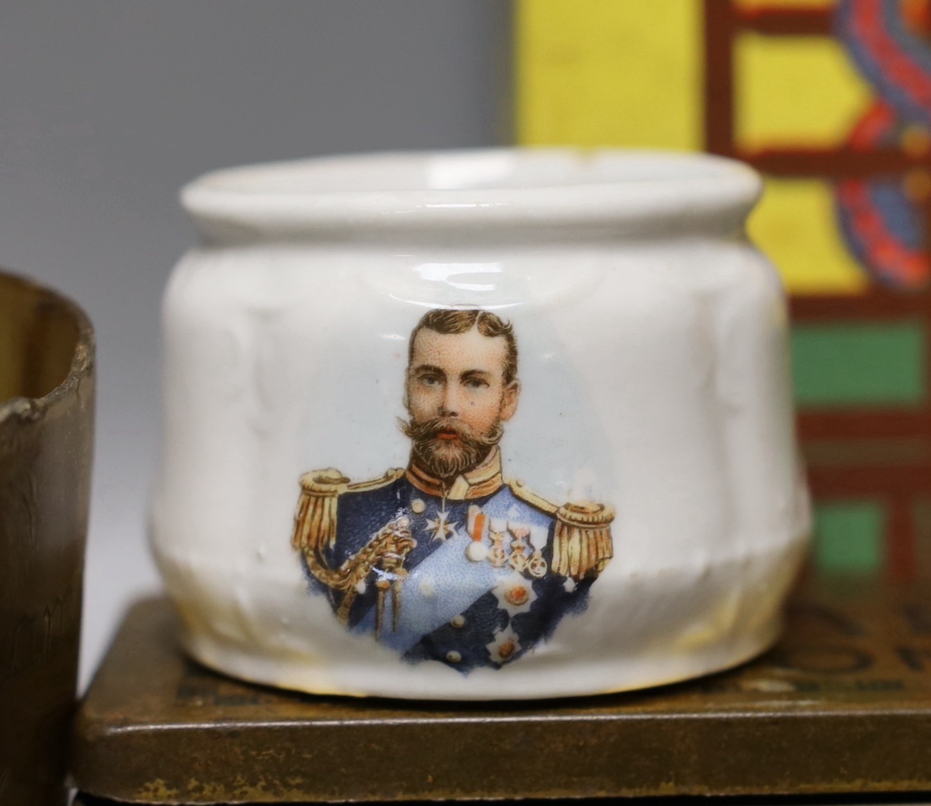 A group of collectables including a Boer War horn cup, a 1930's Betty Boop ceramic scent bottle, a commemorative Wedgwood Nelson jug, etc.